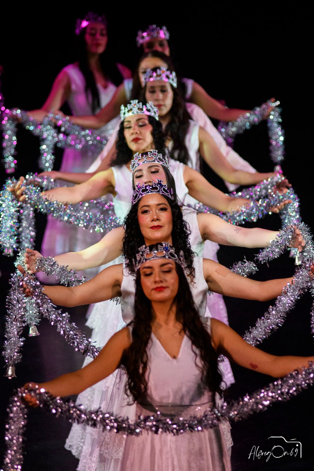 Dancers in colorful costumes on stage.