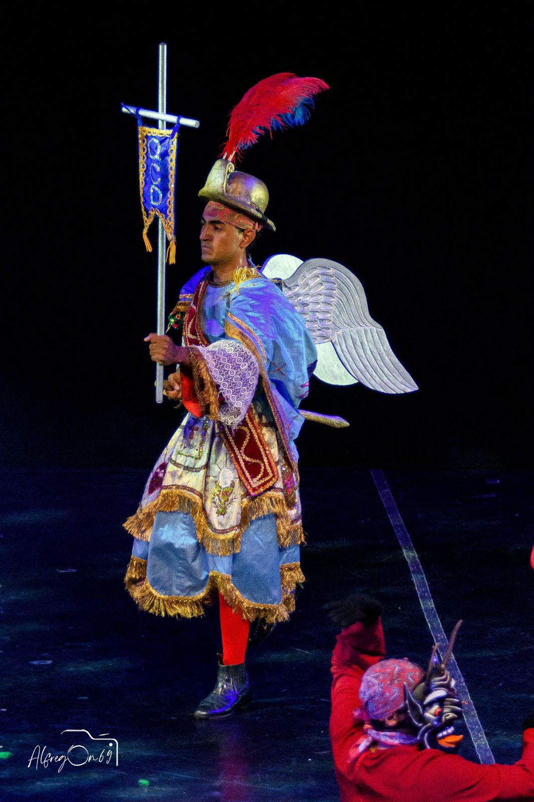 Dancers in blue and white costumes.